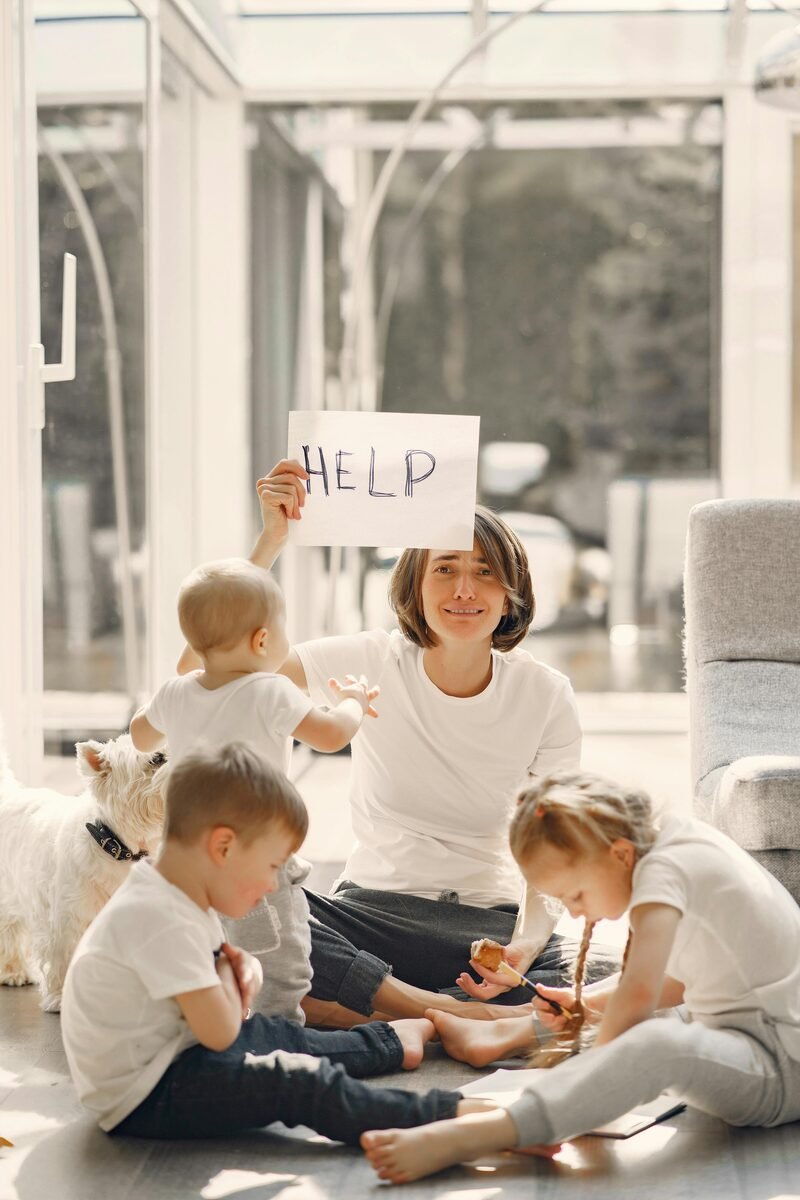 Tired parent sitting with children at home