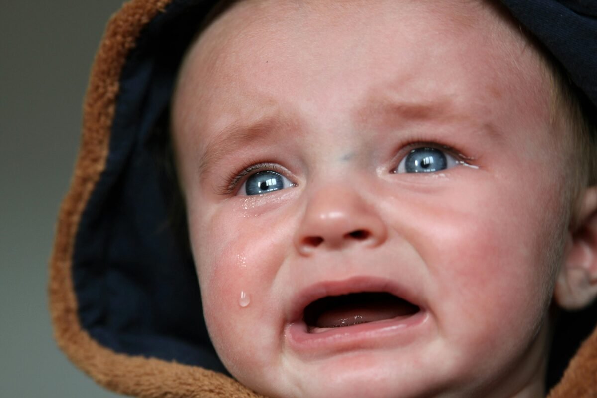 Emotional child moment with parent nearby